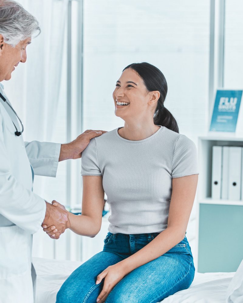 Smile, woman and handshake with doctor in hospital for greeting, introduction and meeting of treatment success. Happy, patient and expert for medical welcome, healthcare agreement and recovery advice Smile, woman and handshake with doctor in hospital for greeting, introduction and meeting of treatment success. Happy, patient and expert for medical welcome, healthcare agreement and recovery advice.